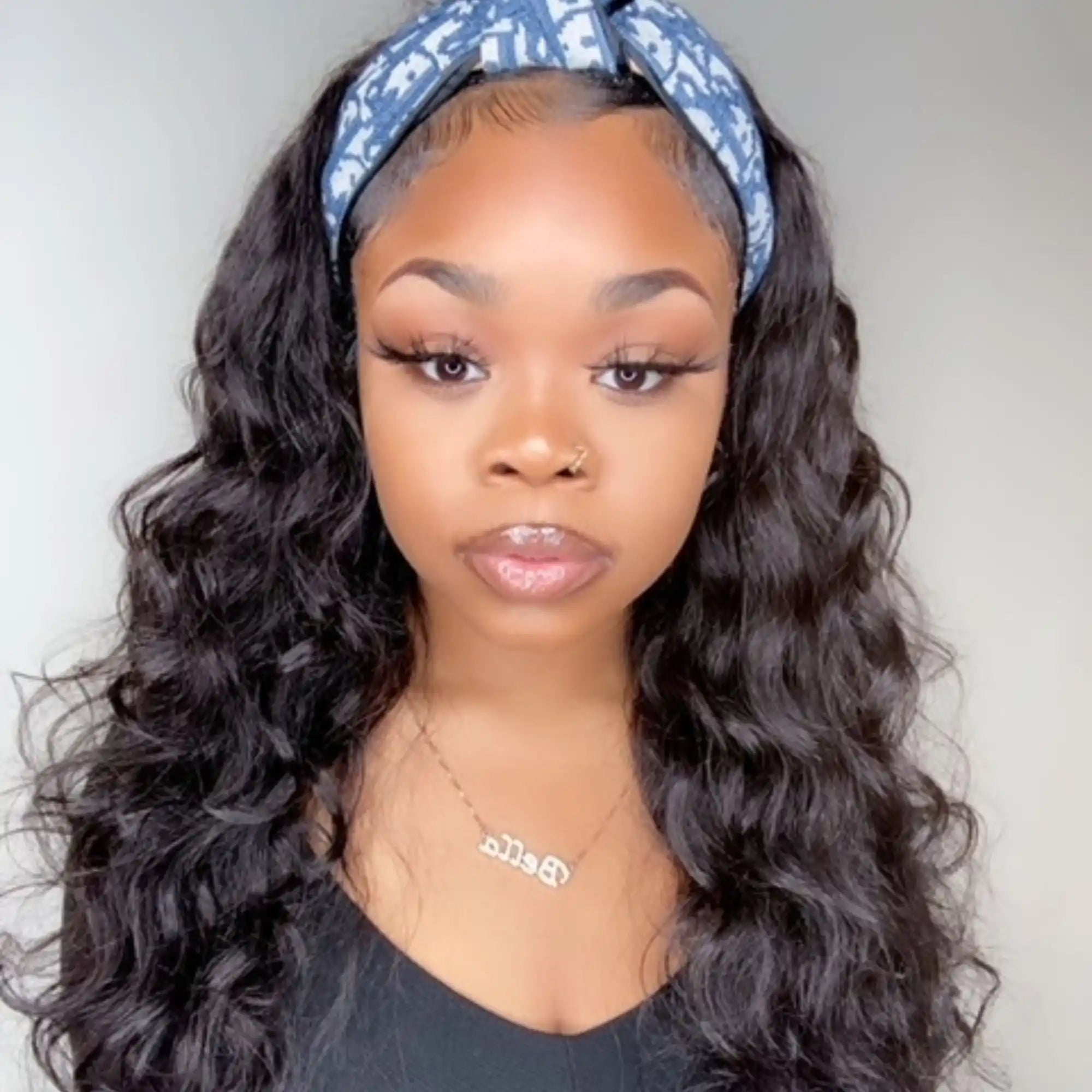 Beautiful wavy black hair styled with a blue and white patterned headband.