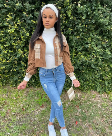 Casual outfit featuring a white turtleneck, tan jacket, distressed jeans, white headband and sneakers.