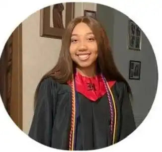 Graduate wearing academic regalia with a red stole and honor cords.
