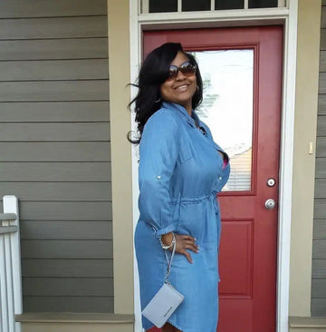 Stylish denim dress with a belted waist and button-front design.